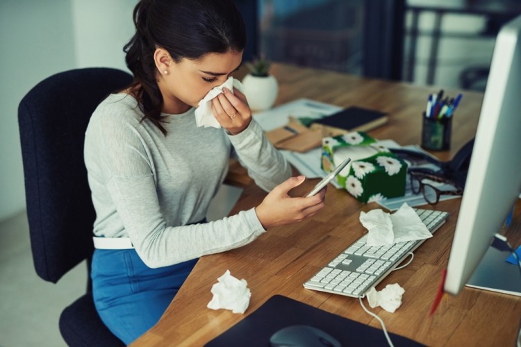 staff member feeling fever and cold in office